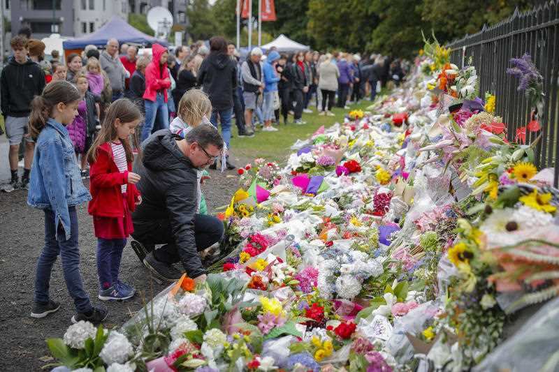 Mourners lay flowers on a wall at the Botanical Gardens in Christchurch.