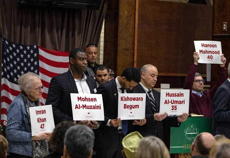 American religious leaders hold the names of the shooting victims from the New Zealand Mosque at a vigil in Falls Church, Virginia. 