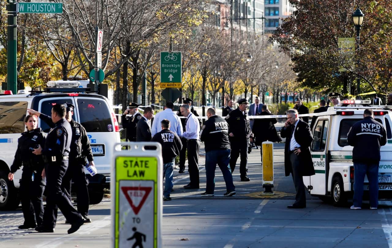 Emergency personnel secure the scene of an incident where a man reportedly drove a truck along a bike lane in downtown New York, New York, USA