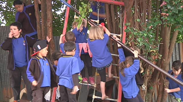 The children are encouraged to play with the junk strewn around the playground.