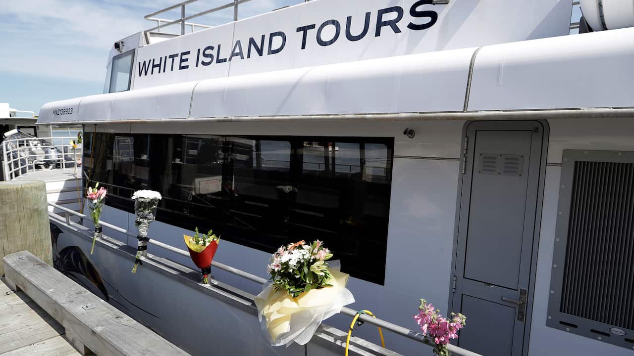 Bouquets of flowers sit on one of the two tour boats that went to White Island.