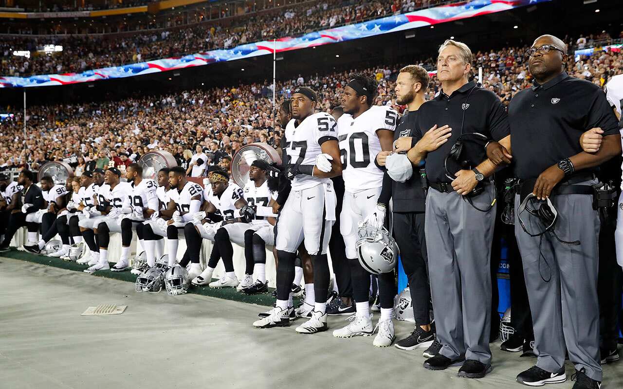 Members of Oakland Raiders sit on the bench before game against Washington Redskins in Landover. 