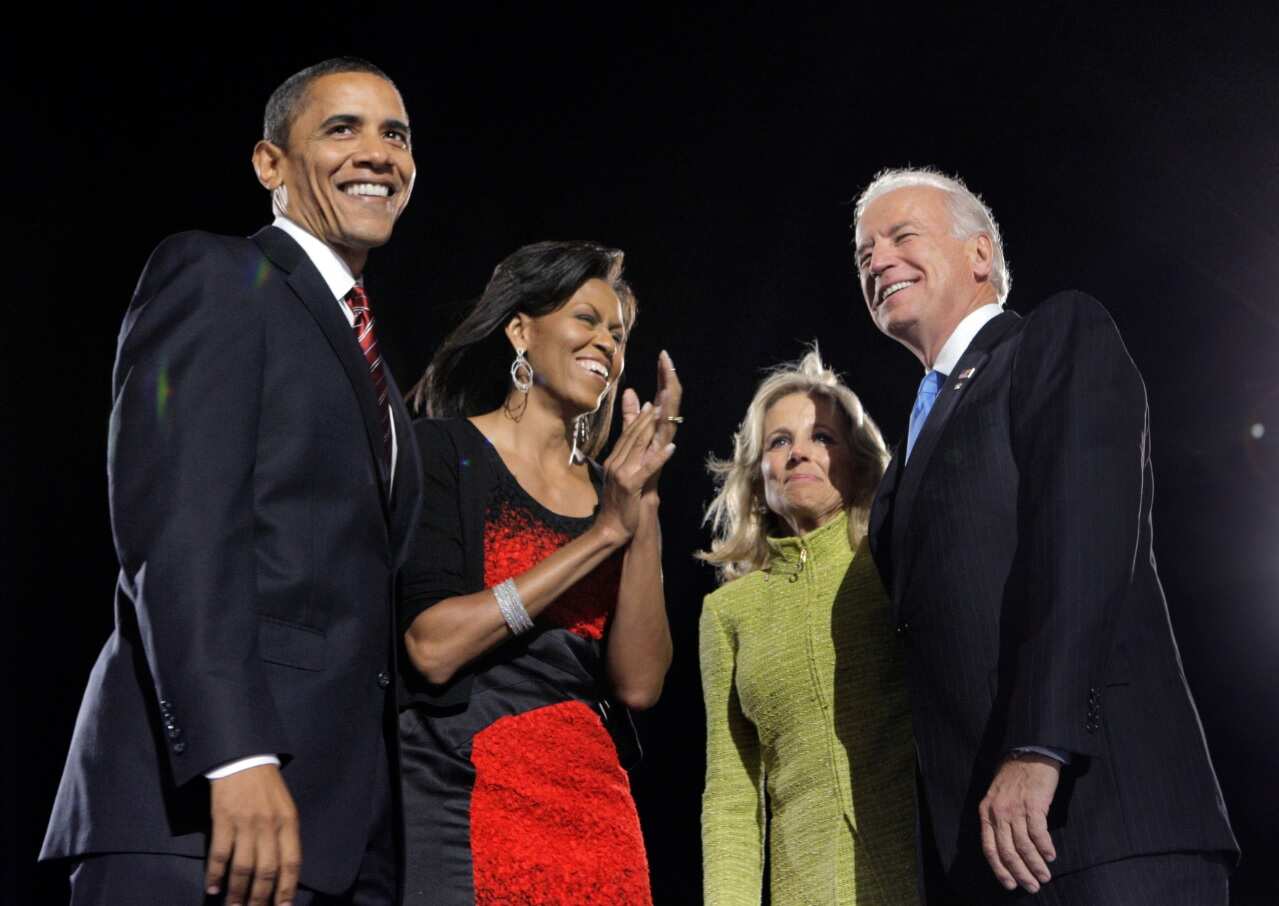 Barack Obama and his wife, Michelle, left, and Vice President-elect Joe Biden and his wife, Jill, celebrate after Obama's acceptance speech in 2008 (AAP)