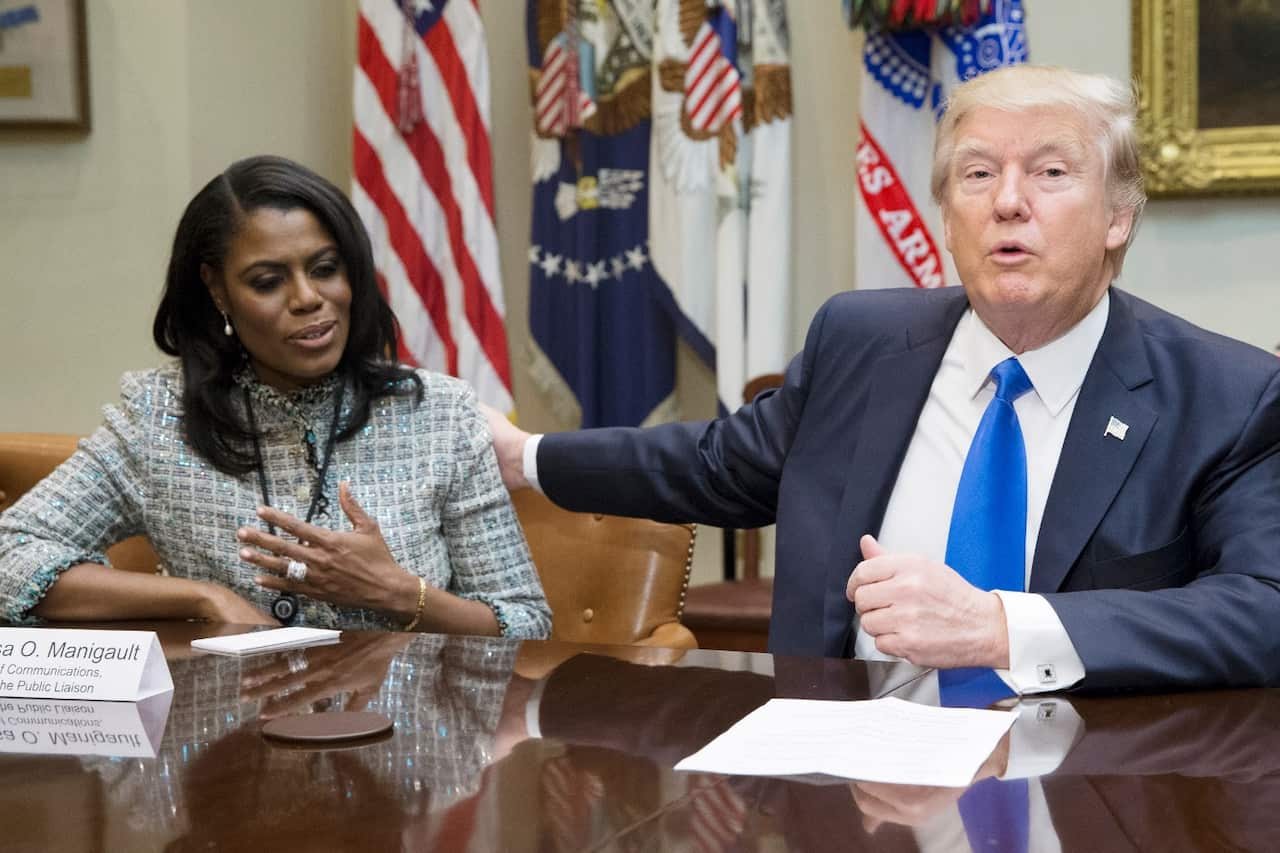 US President Donald J. Trump (R) speaks beside then Director of Communications for the Office of Public Liaison Omarosa Manigault-Newman (L)
