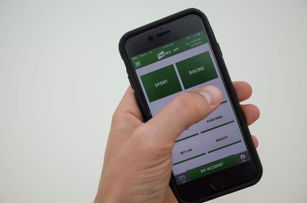 A hand holding a smart phone.