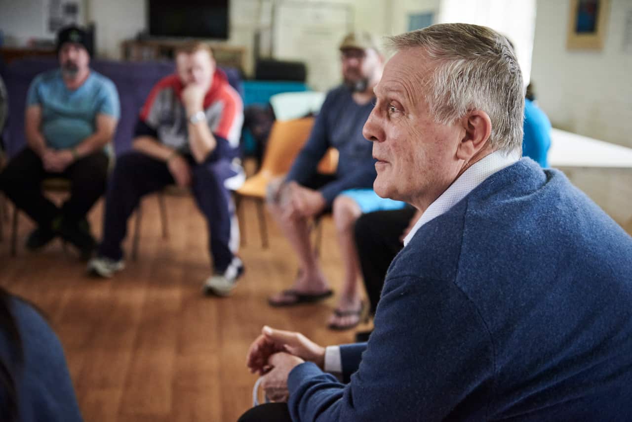 Dr. George O'Neil speaks with men residing at the Fresh Start Recovery Program in Subiaco, Australia