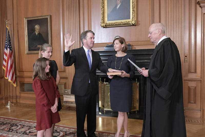 Retired Justice Anthony M. Kennedy administers the Judicial Oath to Judge Brett Kavanaugh in the Justices' Conference Room of the Supreme Court Building.