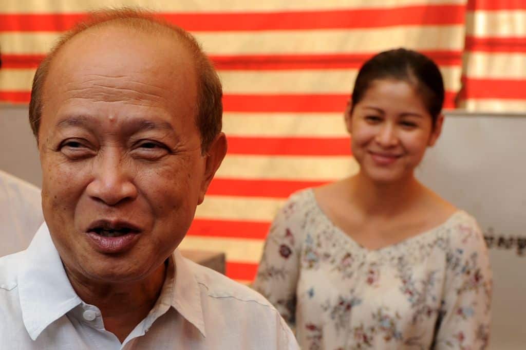  Prince Norodom Ranariddh and his wife Ouk Phalla  after casting their votes at a polling station in Phnom Penh.