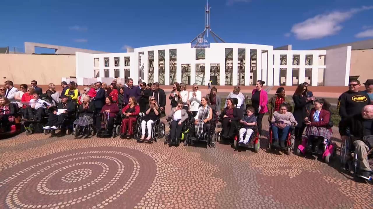 A group of people living with SMA gathered outside of Parliament House.