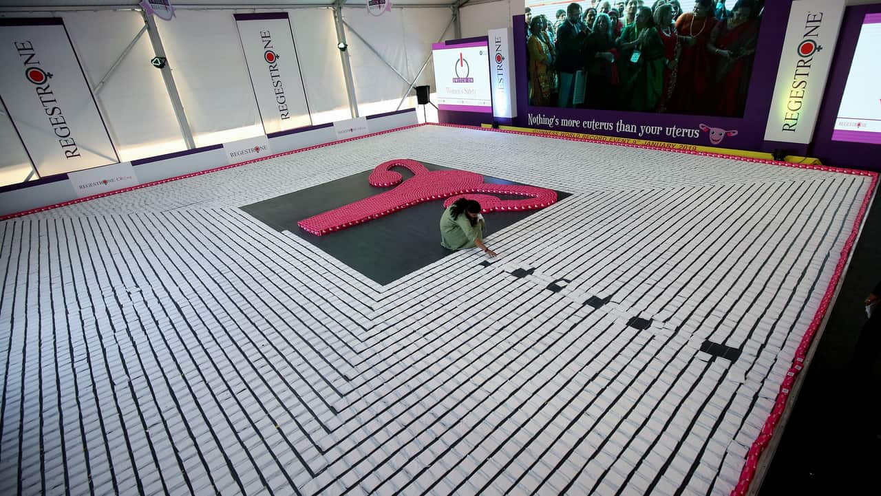 An Indian woman arrange the sanitary napkins during a successful attempt for a Guinness world record.