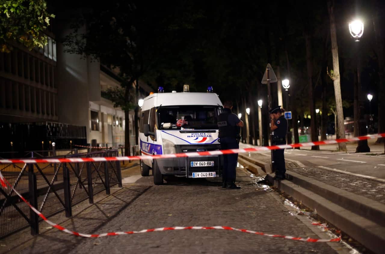 Police officers secure the site of a knife attack in Paris, Monday, Sept. 10, 2018. 