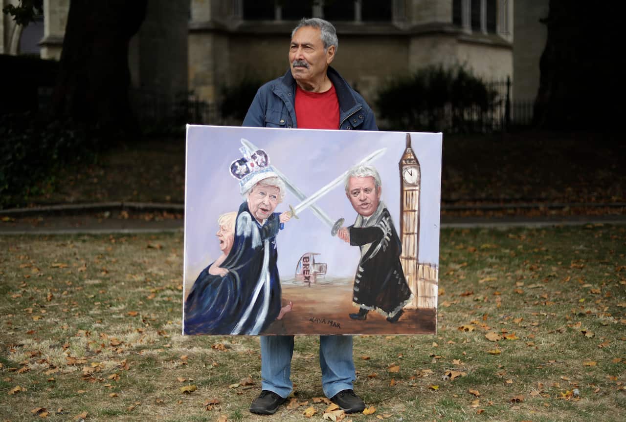 The speaker has been criticised for becoming increasingly political about Brexit. Political artist Kaya Mar holds his painting of British Prime Minister Boris Johnson, Queen Elizabeth II and Mr Bercow.