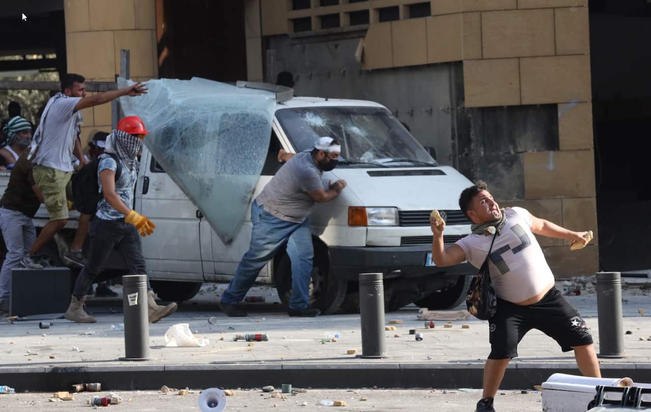 Lebanese anti-government protesters during clashes with riot police during a protest in Beirut, Lebanon, 08 August 2020. 