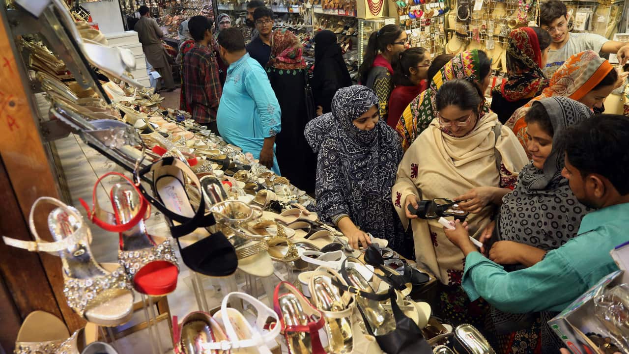 Women visit a market to buy shoes for the Eid al-Fitr celebrations in Lahore, Pakistan.
