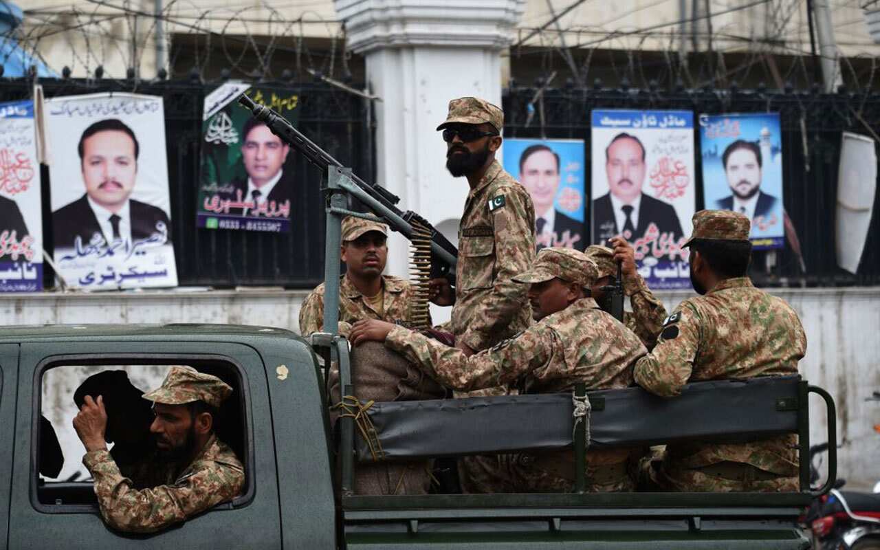 Pakistani soldiers patrol outside a voting material distribution centre in Lahore on July 24, 2018