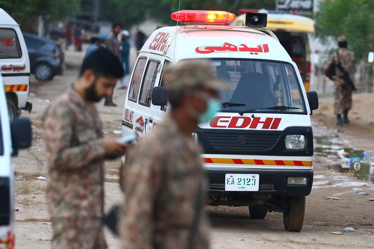 An ambulance attends the scene of a Pakistan International Airlines crash.