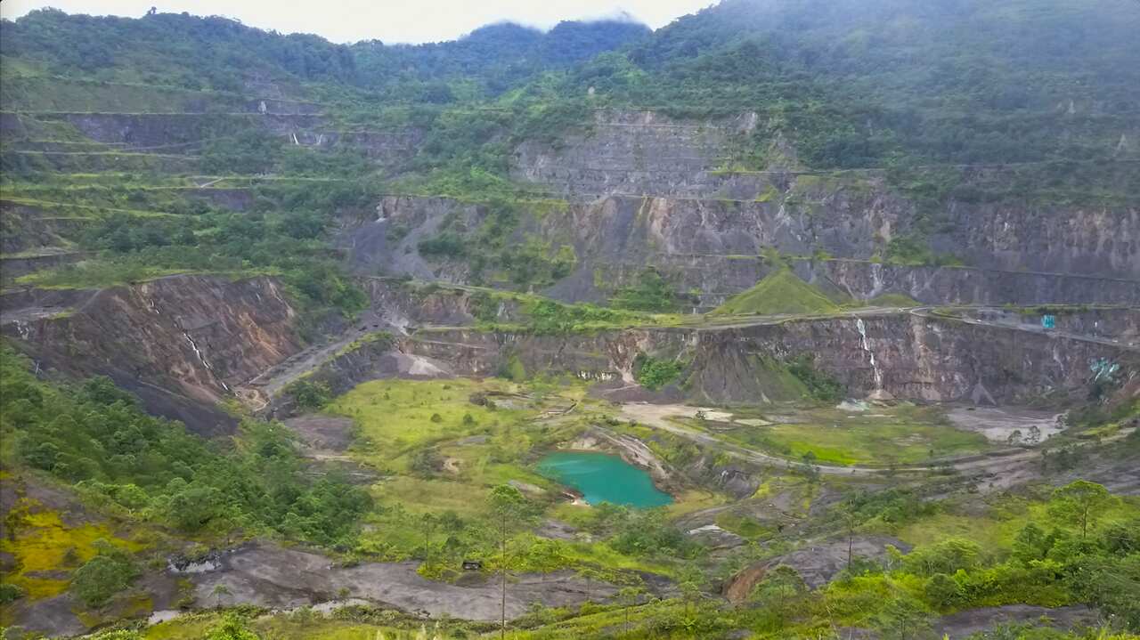 Abandoned Panguna mine pit leaching copper-sulphate water.