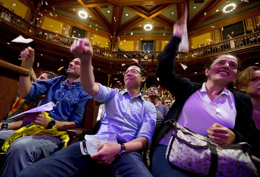 Audience members launch paper planes during Ig Nobel award ceremonies.
