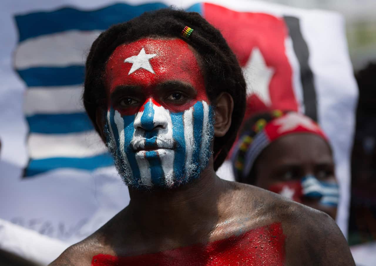 A Papuan student, with his body and face painted with the colors of the banned separatist 'Morning Star' flag.