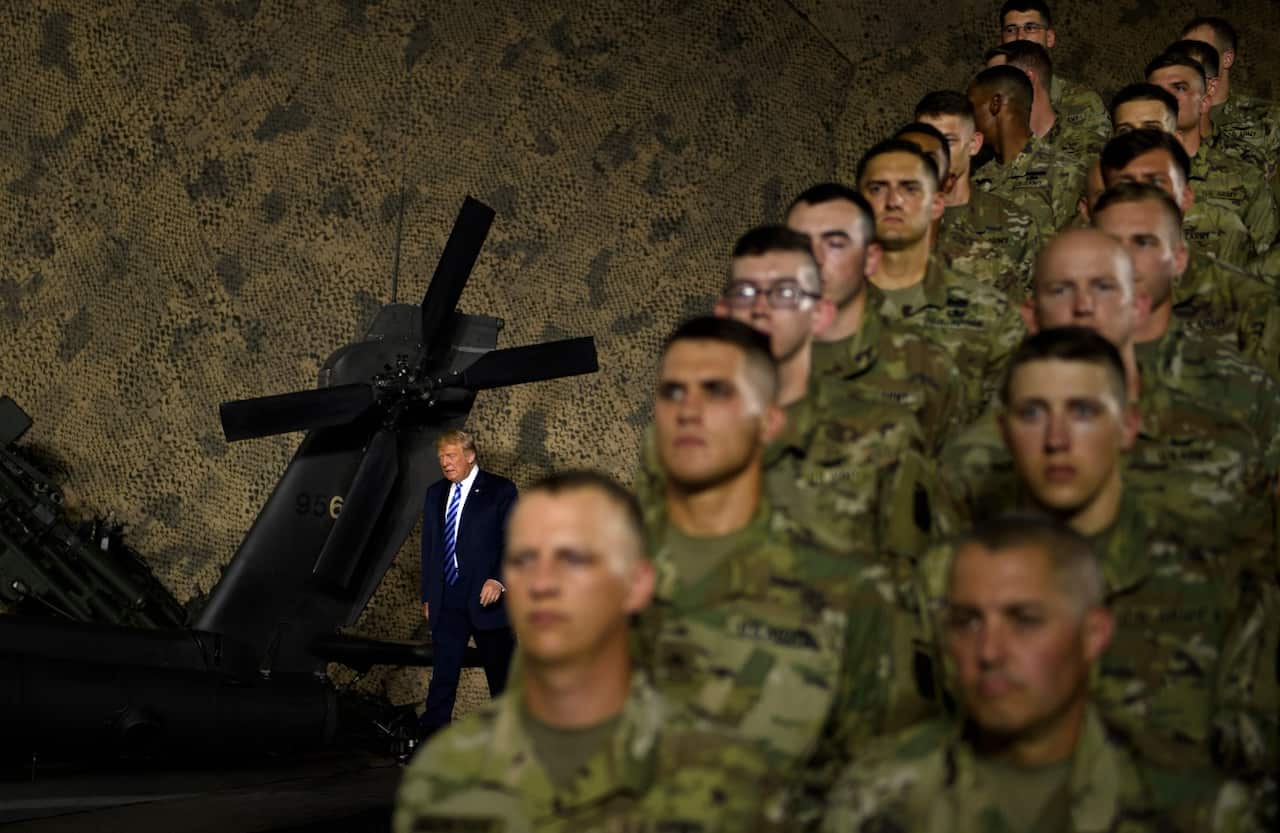 US President Donald Trump arrives to speak at a signing ceremony for the John S. McCain National Defense Authorisation Act for Fiscal Year 2019 
