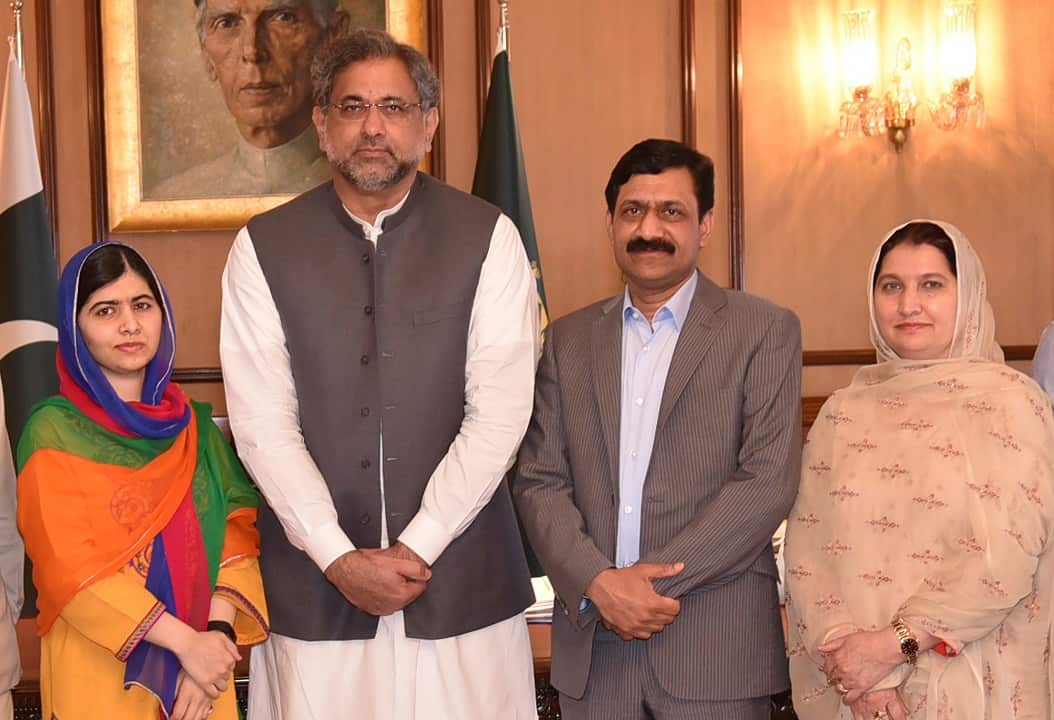 Malala Yousafzai and her parents pose for a photograph with Shahid Khaqan Abbasi, Prime Minister of Pakistan in Islamabad, Pakistan.