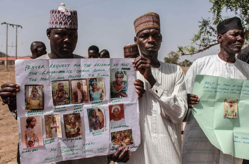 Parents and relatives hold portraits of their girls during a commemoration five years on from their kidnap (Getty Images)