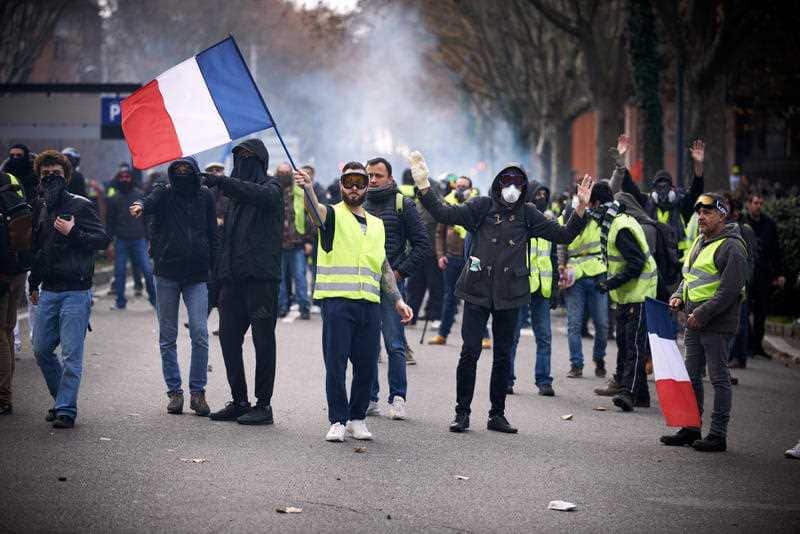 Riot police launched volleys of tear gas canisters yesterday when facing rioters.