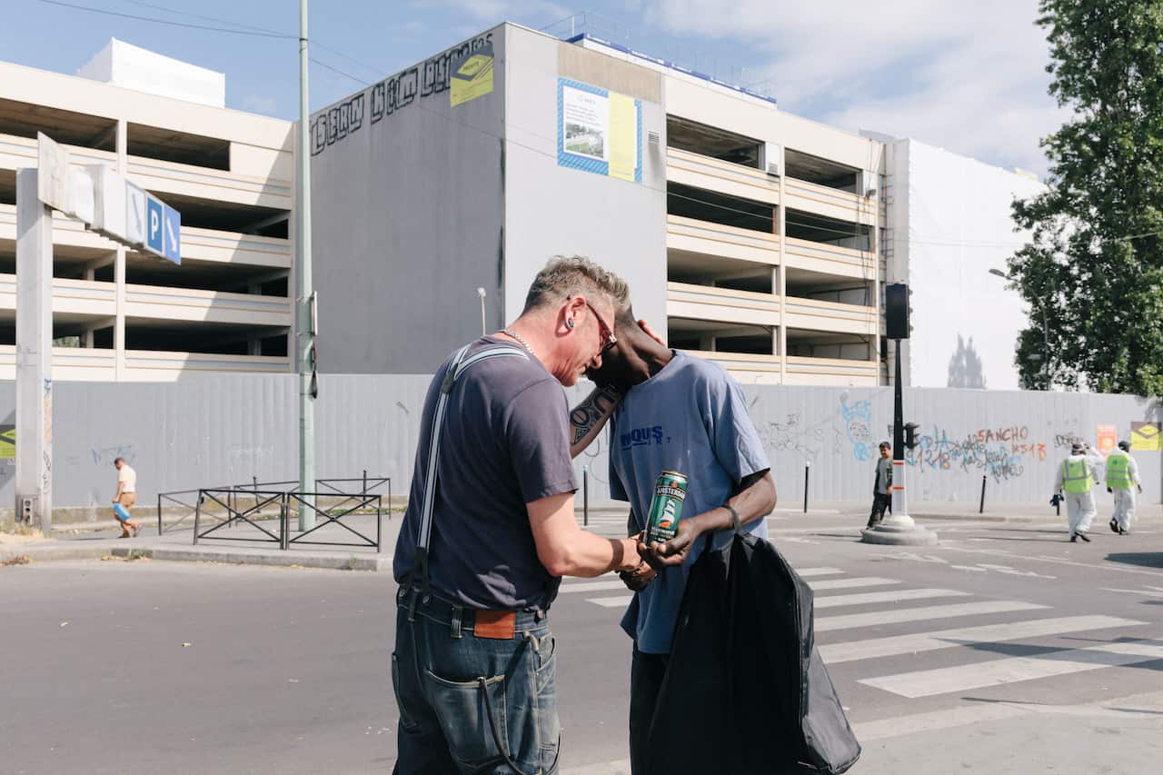Yves Bouillet, left, a social worker for the Charonne aid organization, in the La Colline neighborhood of Paris, July 30, 2019