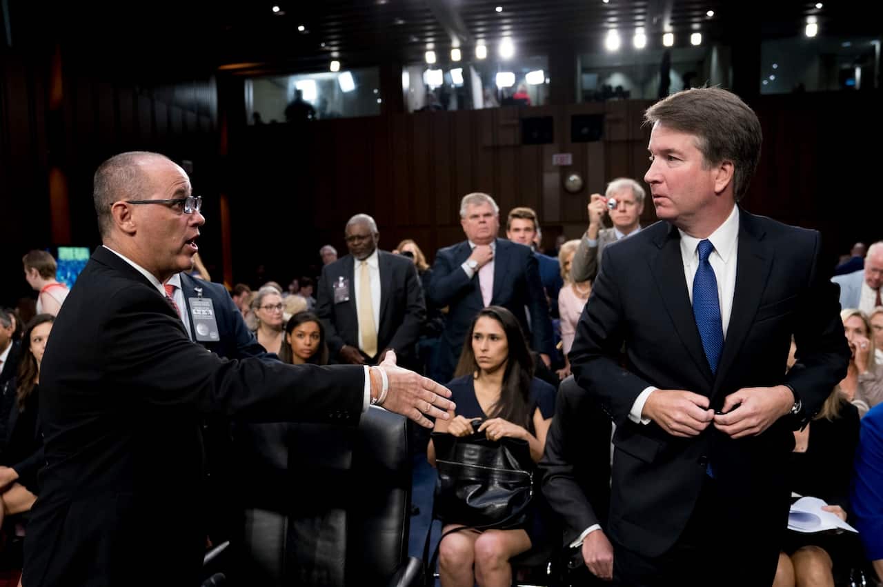Fred Guttenberg, the father of Jamie Guttenberg who was killed in the Stoneman Douglas High School shooting in Parkland, Fla., left, attempts to shake hands