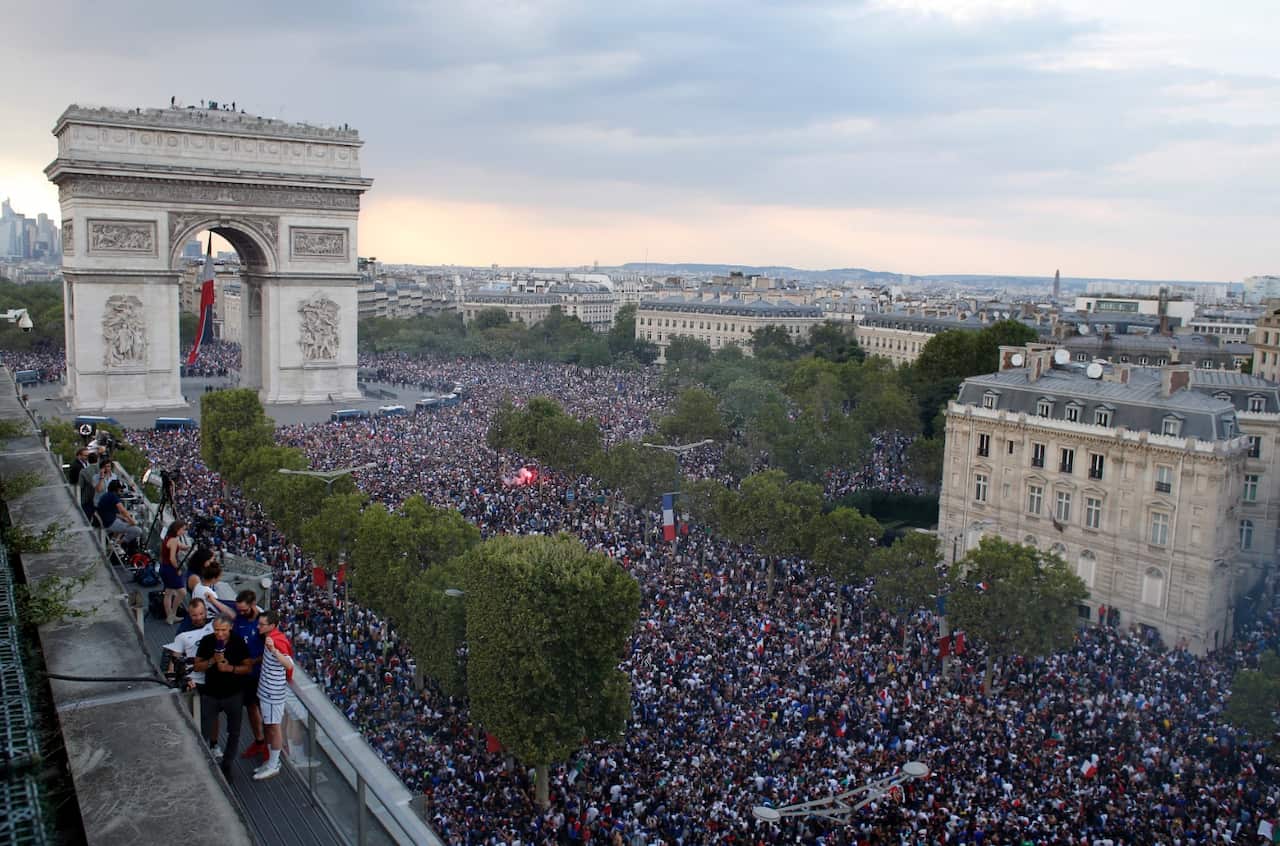 In this picture taken from the terrace of the Publicis Group people take the streets around the Arc de Triomphe to celebrate France's World Cup victory