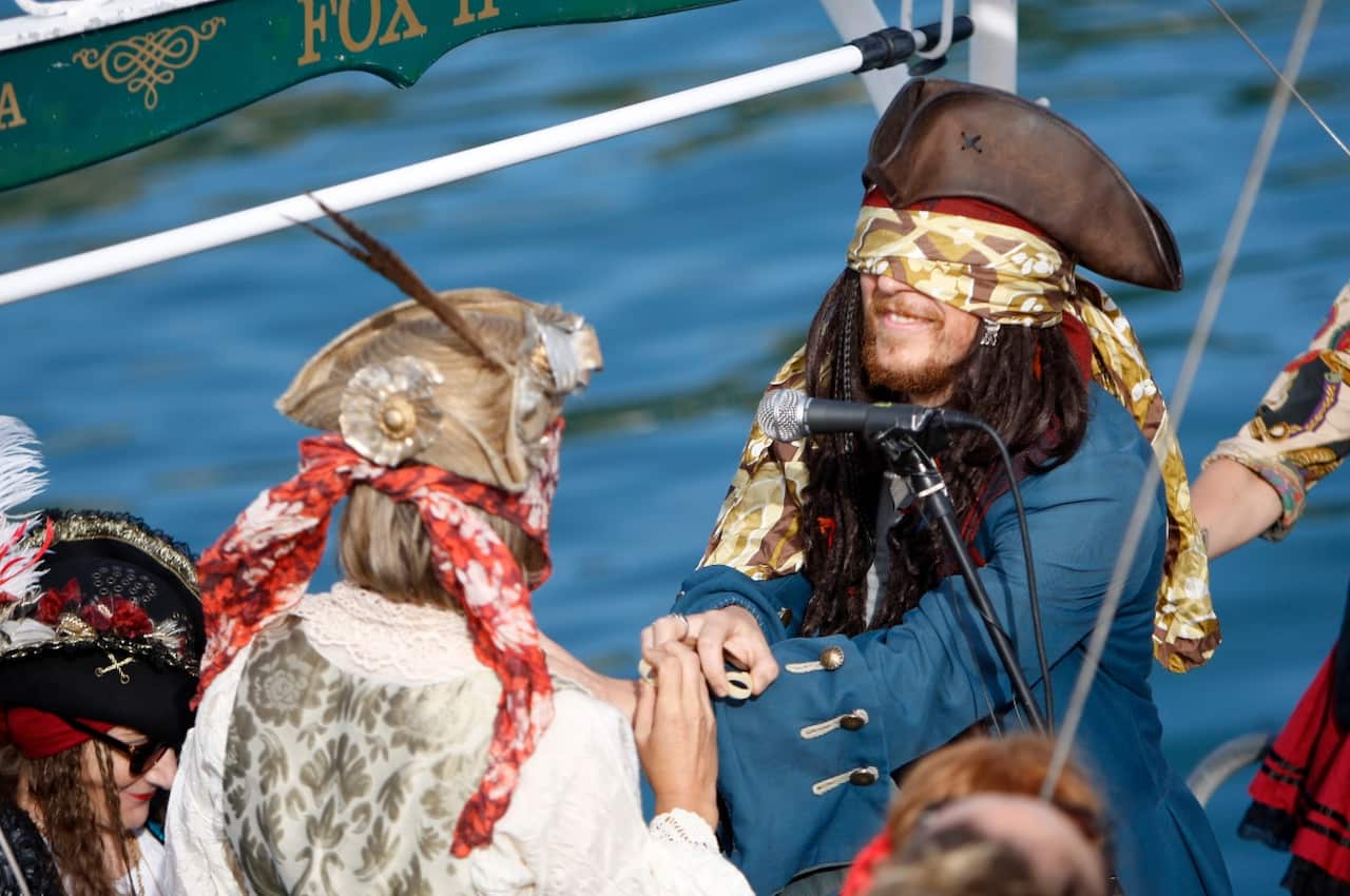 Bride Marianna Fenn, left, and bridegroom Toby Ricketts hold rings made of pasta during their marriage ceremony