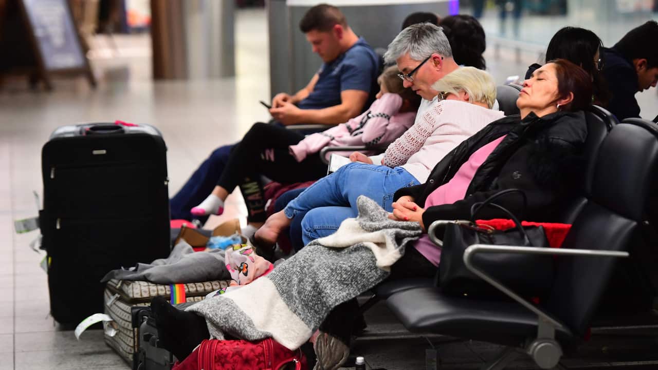Passengers sleeping at Gatwick airport.