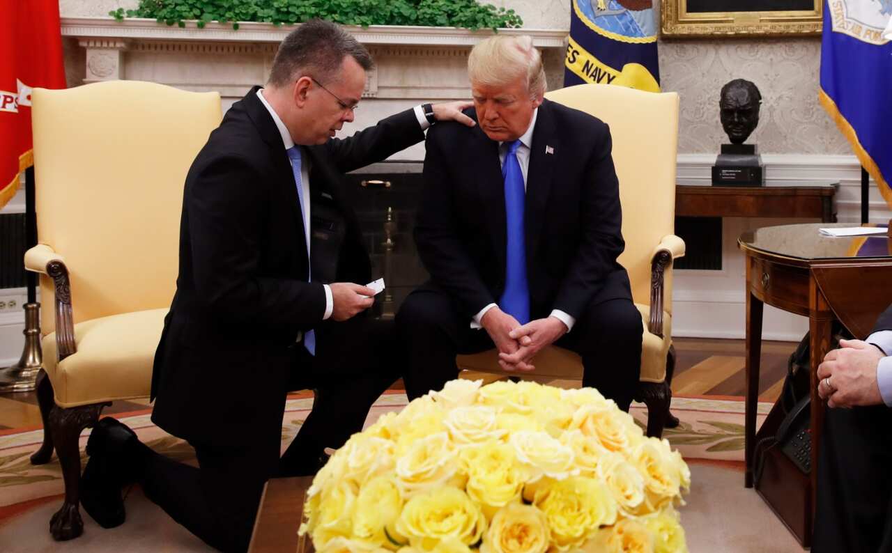 President Donald Trump prays with American pastor Andrew Brunson in the Oval Office of the White House, Saturday October 13, 2018