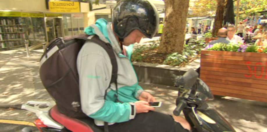 Patrick Psotka checks his phone for delivery orders. 