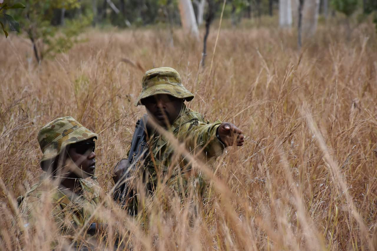 Edmund Laza directs a recruit during a patrol.