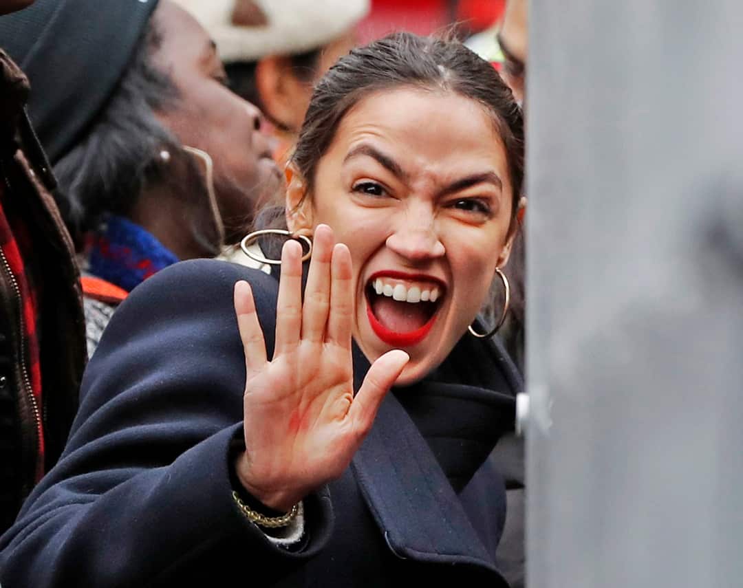 U.S. Rep. Alexandria Ocasio-Cortez, D-New York, waves to supporters as she arrives at a rally organized by Women's March NYC at Foley Square in Lower Manhattan, Saturday, Jan. 19, 2019, in New York. (AP Photo/Kathy Willens)