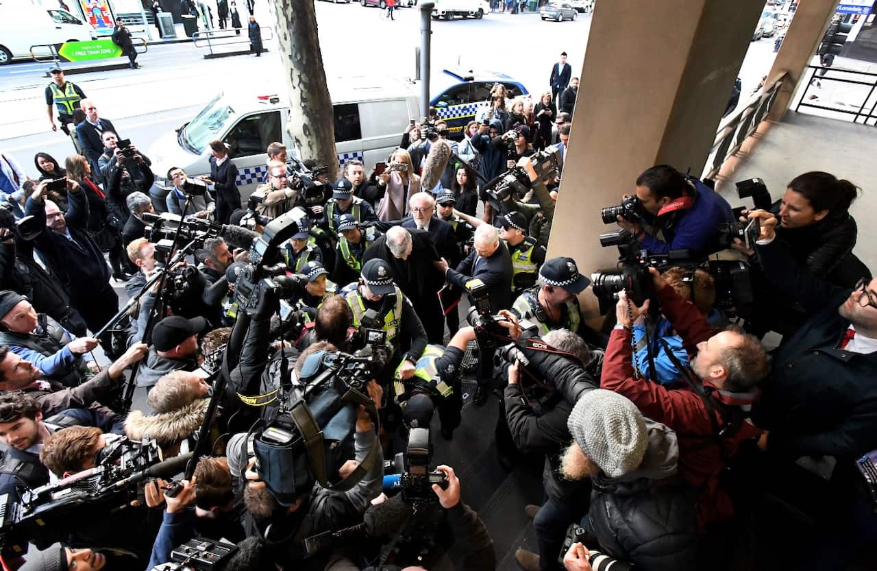 Cardinal George Pell escorted by police departs the Melbourne Magistrates Court in Melbourne, Wednesday, July 26, 2017 (AAP)