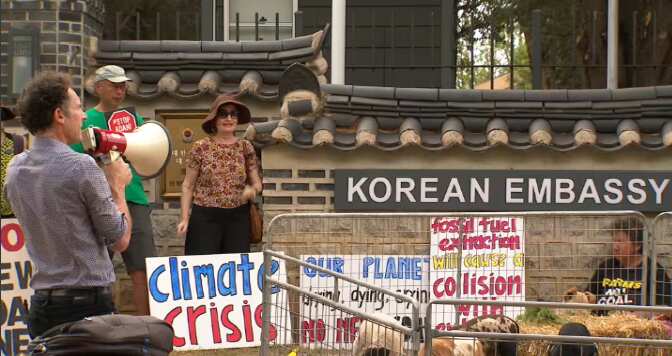 The group gathered outside the embassy.