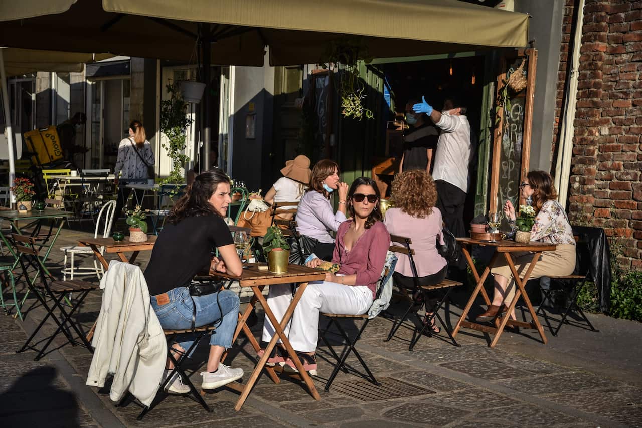 People at a restaurant in Milan (AAP)