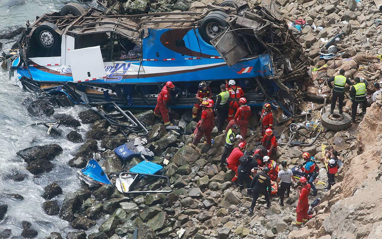 A group of emergency personnel working to rescue victims after a passenger bus plunged off the Pan-American Highway North, about 45 kilometers from Lima.