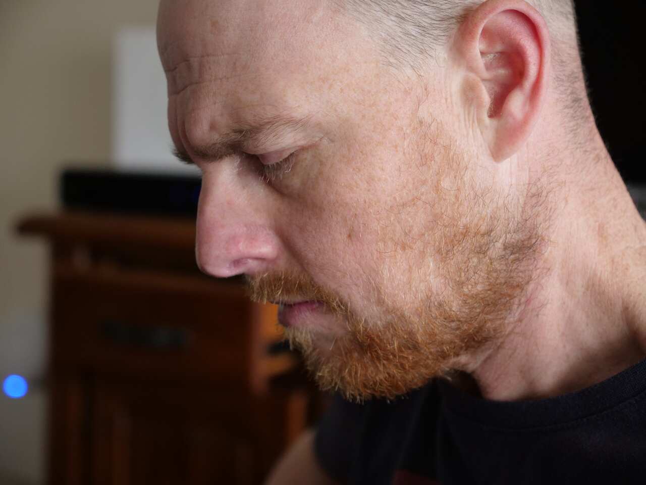 Peter Gordon playing the acoustic guitar at his home in Hobart.