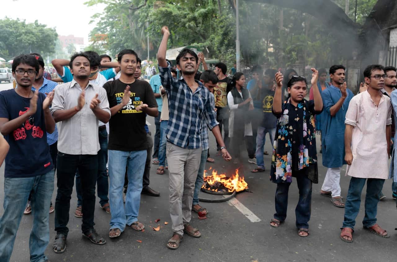 Bangladeshis shout slogans during a protest against the removal of a Lady Justice statue in Dhaka, Bangladesh, Friday, May 26, 2017. (AAP)