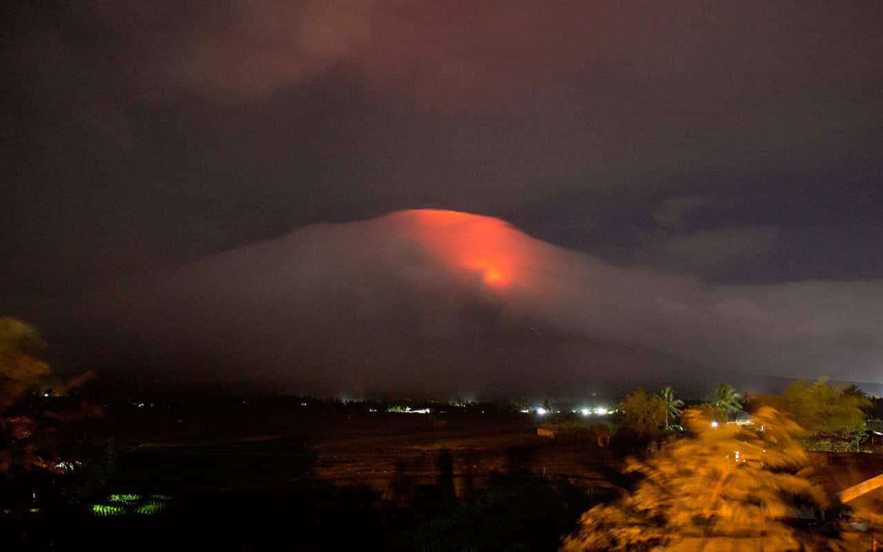 Photo provided by Earl Recamunda, an orange glow is seen at the cloud-shrouded crater of Mayon volcano at Legazpi city, Albay province.