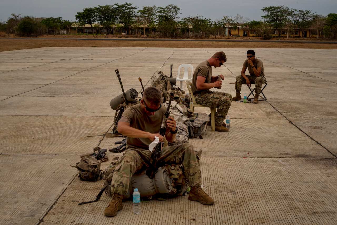 American soldiers await transport after a military exercise on Lubang Island in the Philippines.
