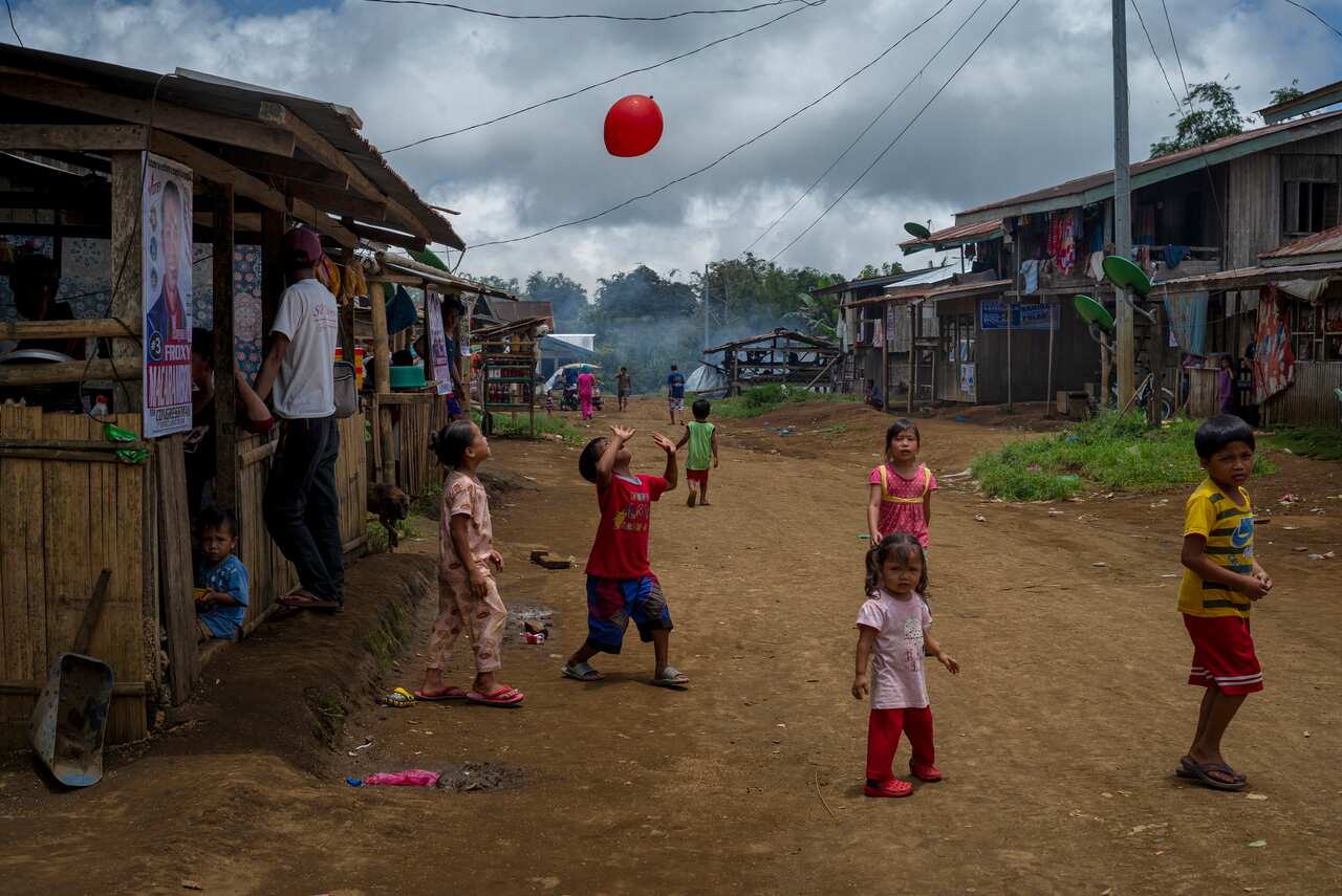 Children play by the road in Padas, the Philippines.