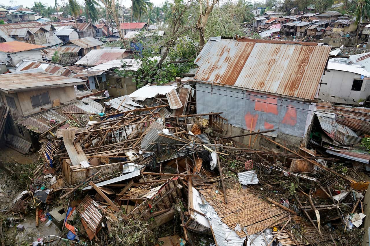 Debris is scattered over damaged homes from Typhoon Rai in Talisay, Cebu province, central Philippines.