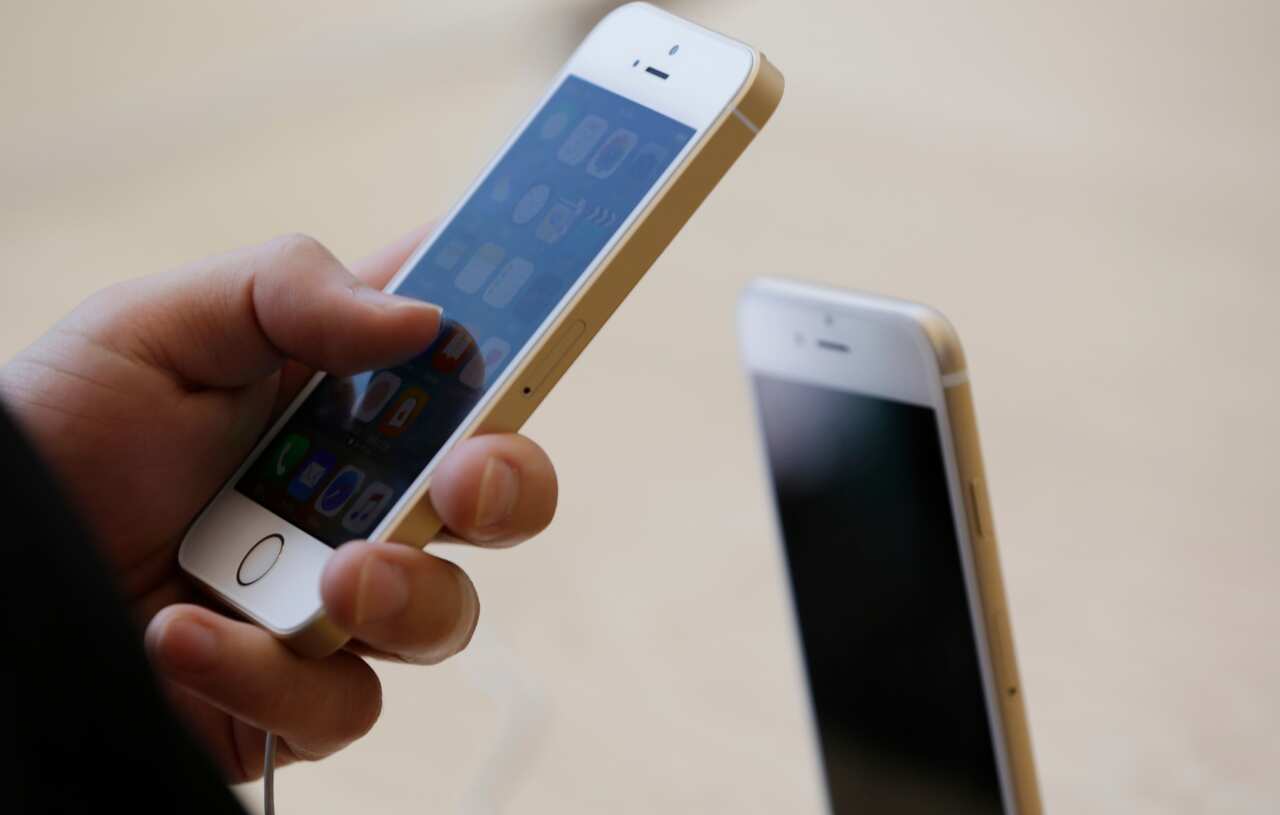 A file image of a person using the Apple iPhone SE
