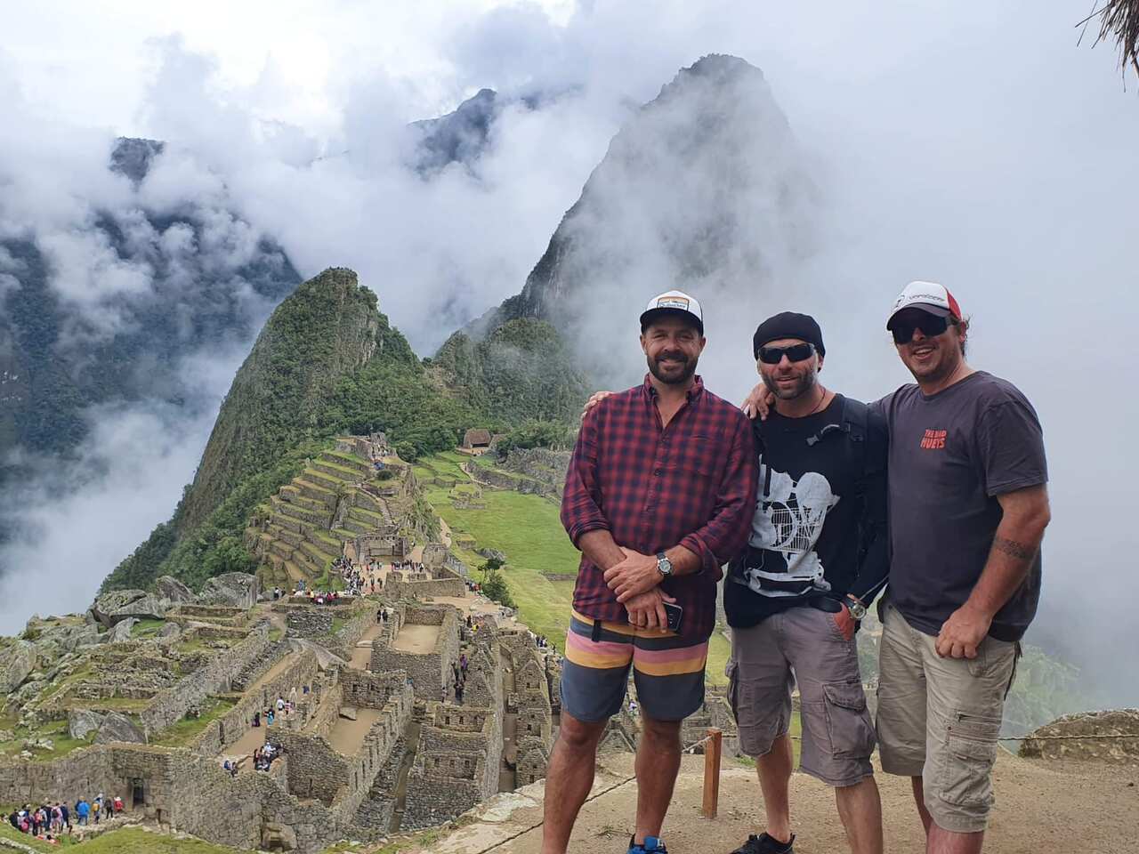 Mr Cruise poses with friends at the Incan citadel of Machu Picchu, high in the Andes Mountains of Peru.
