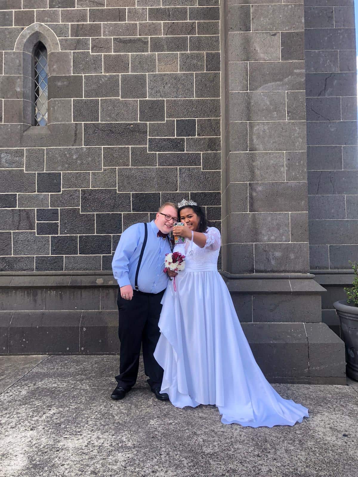 Chris and Amelinda taking a selfie on their wedding day.