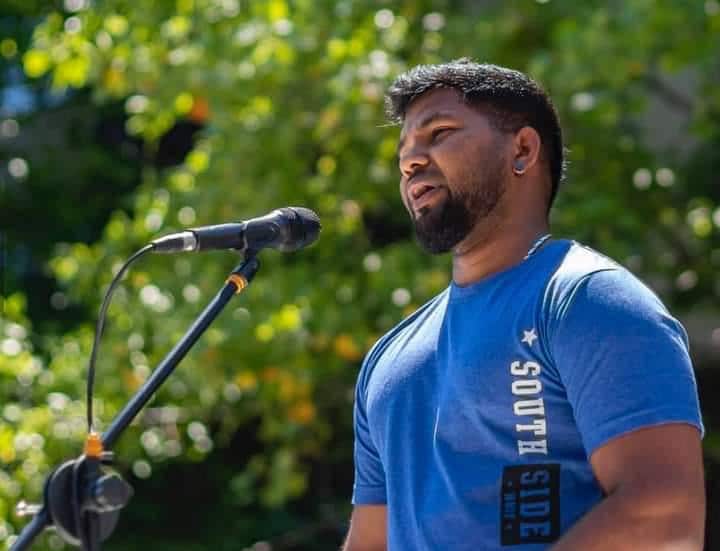 Sri Lankan refugee Thanush Selvarasa giving a speech 